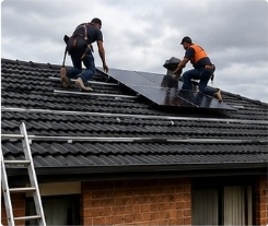 Workers installing solar on roof